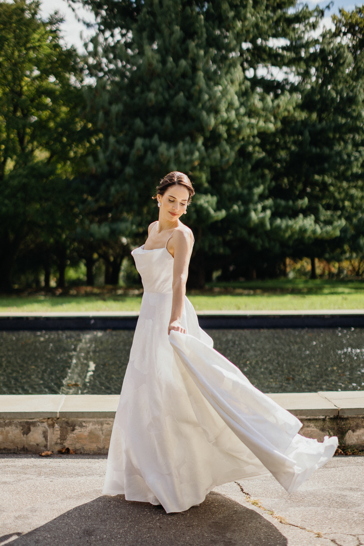Bride standing alone in the garden at the Horticulture Center