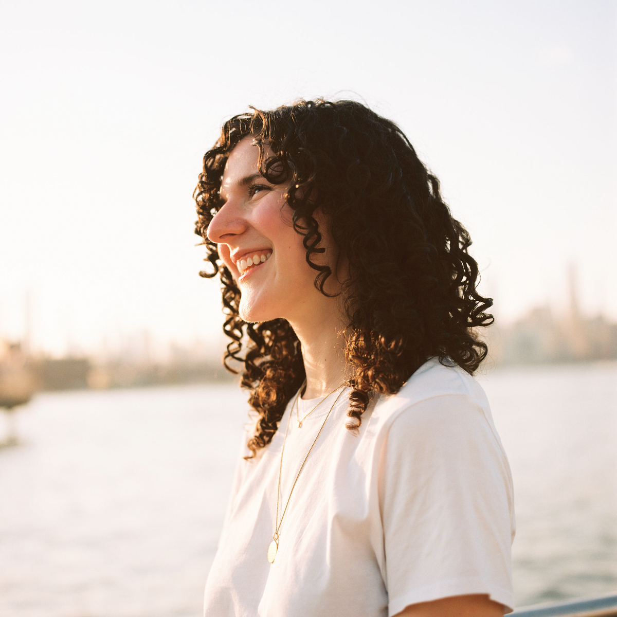 Medium format film photographer documenting relaxed moments in a Brooklyn engagement session.
