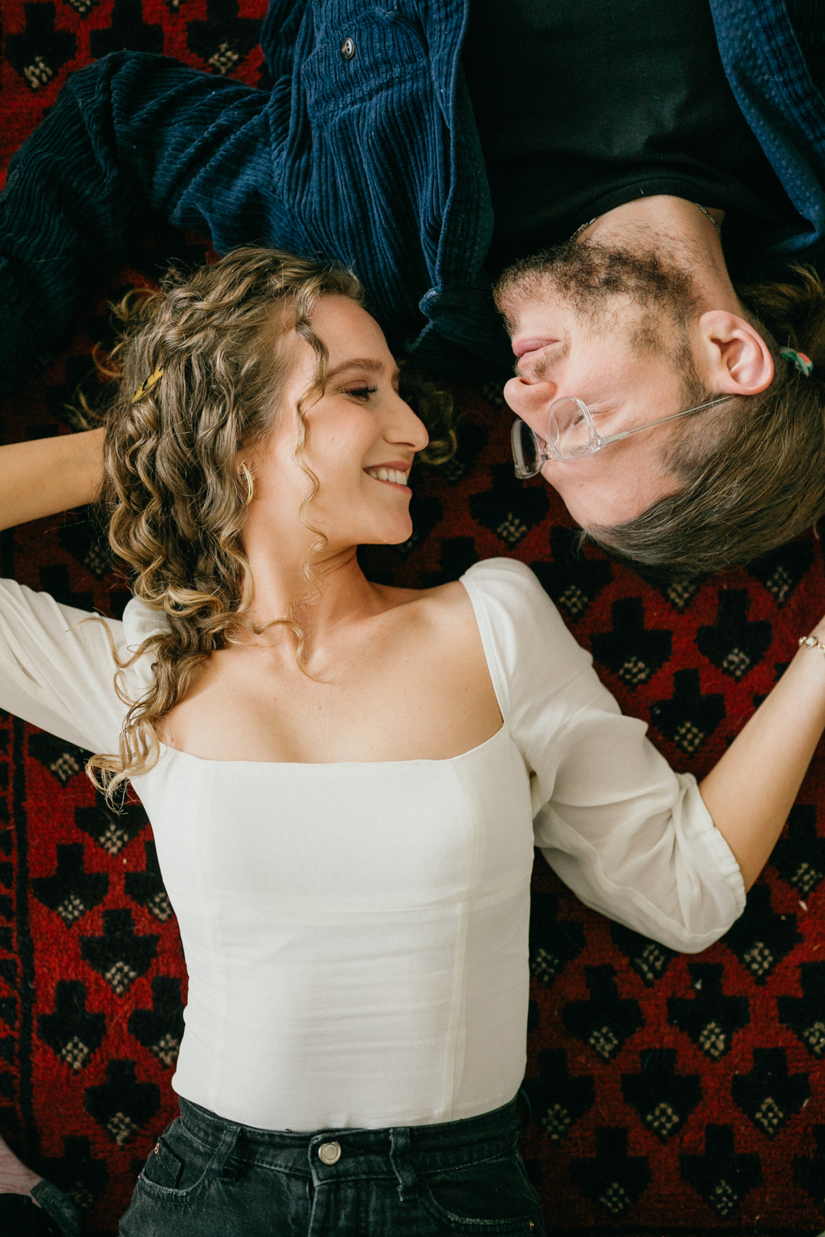 Indoor couples portrait with warm tones and relaxed poses