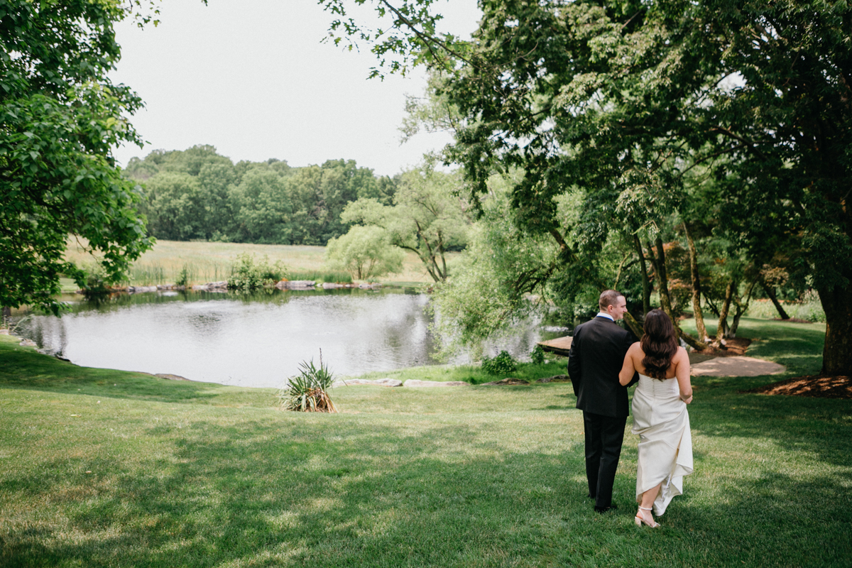 Farm at Eagles Ridge wedding photo showing bride walking near the pond, waterfront wedding venue in Philadelphia