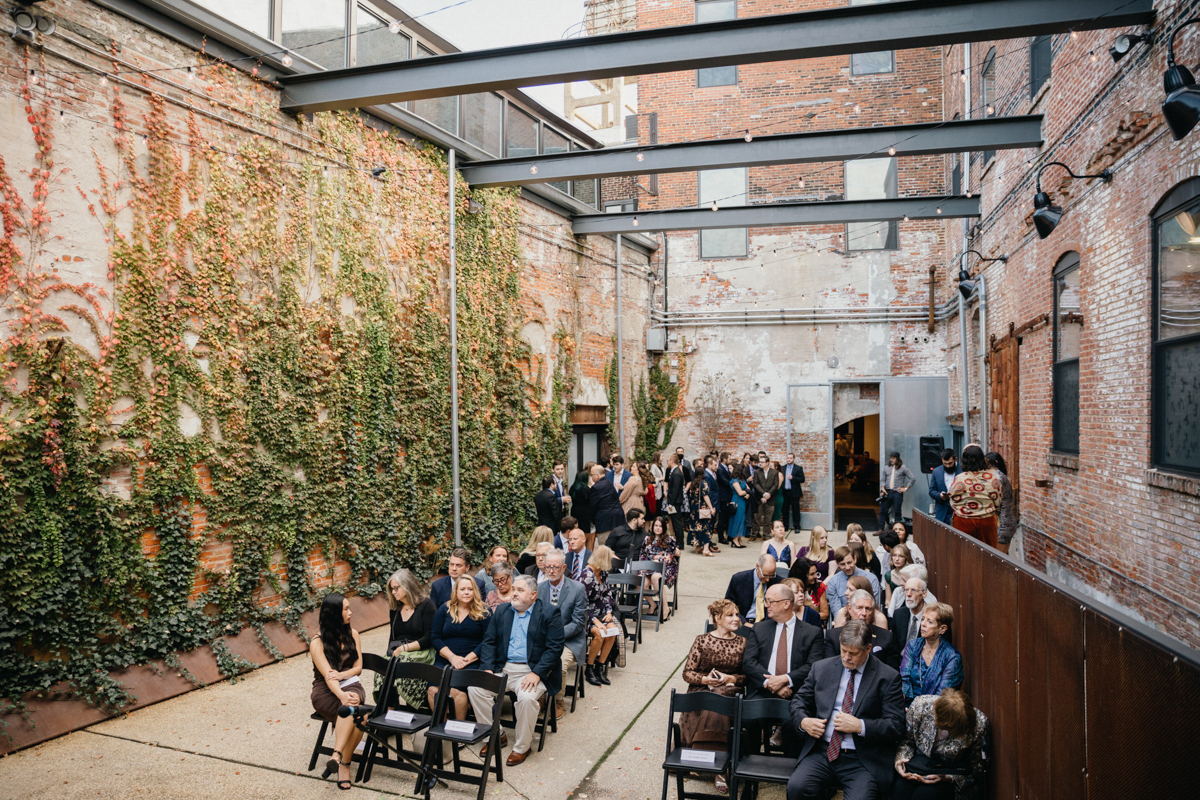 Global Dye Works wedding ceremony in ivy-covered courtyard