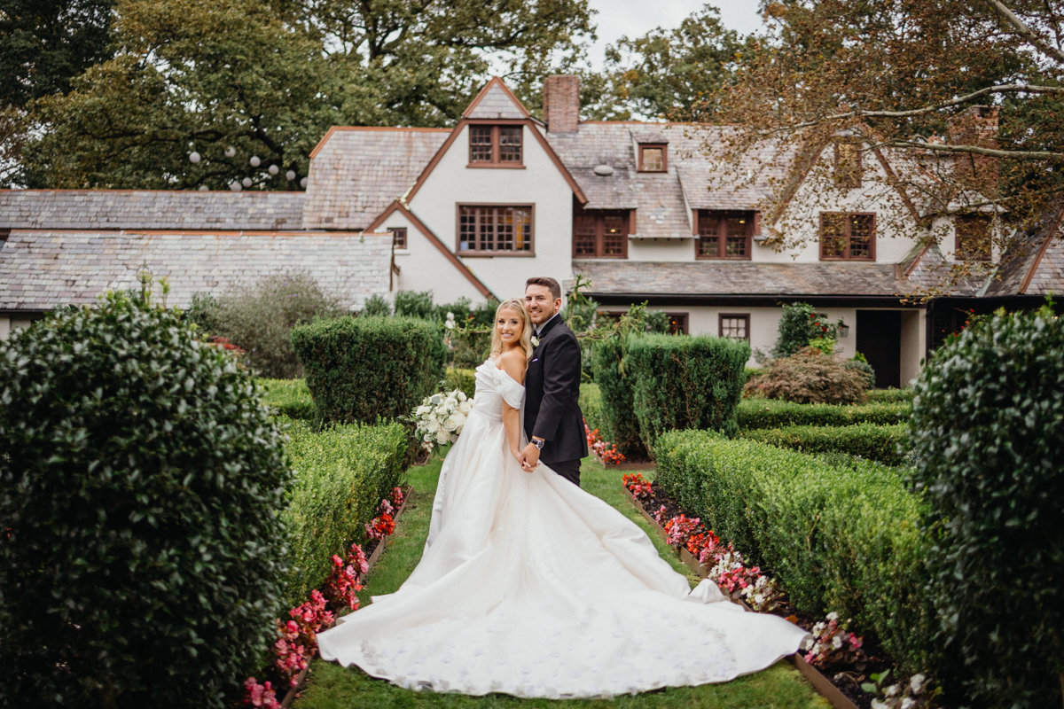 Bride and groom walking through the garden at Hotel Du Village during golden hour
