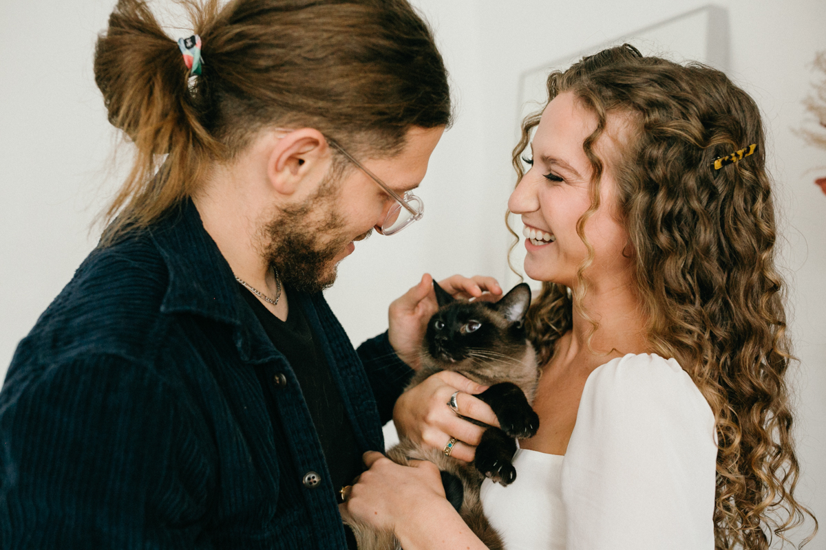 Home engagement photos featuring couple's cat