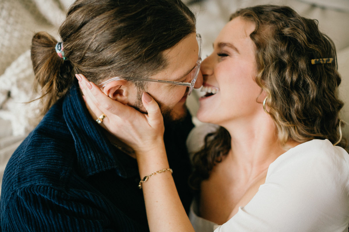 Timeless indoor engagement photo of couple relaxing in their home