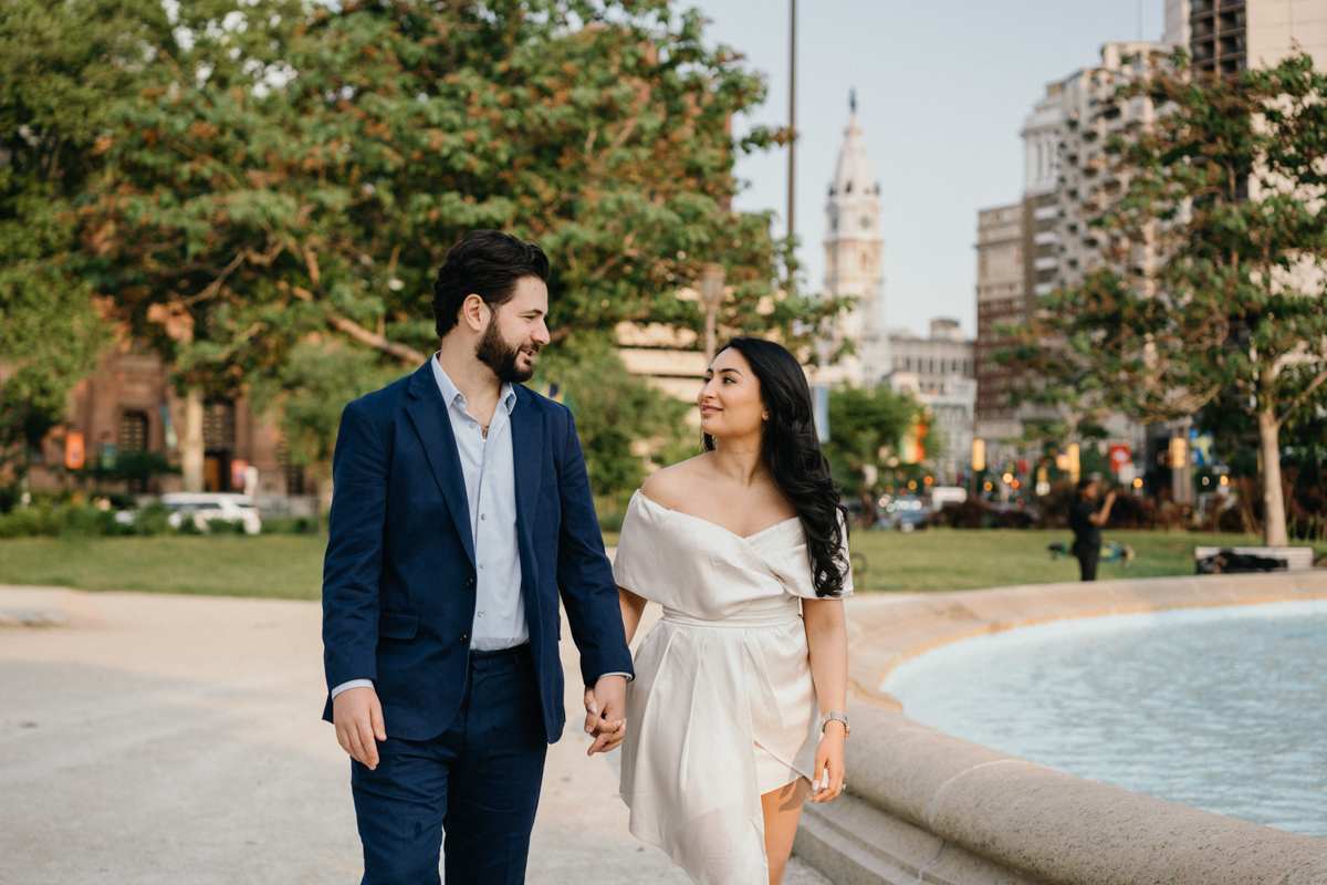 City skyline view behind couple during Art Museum engagement shoot