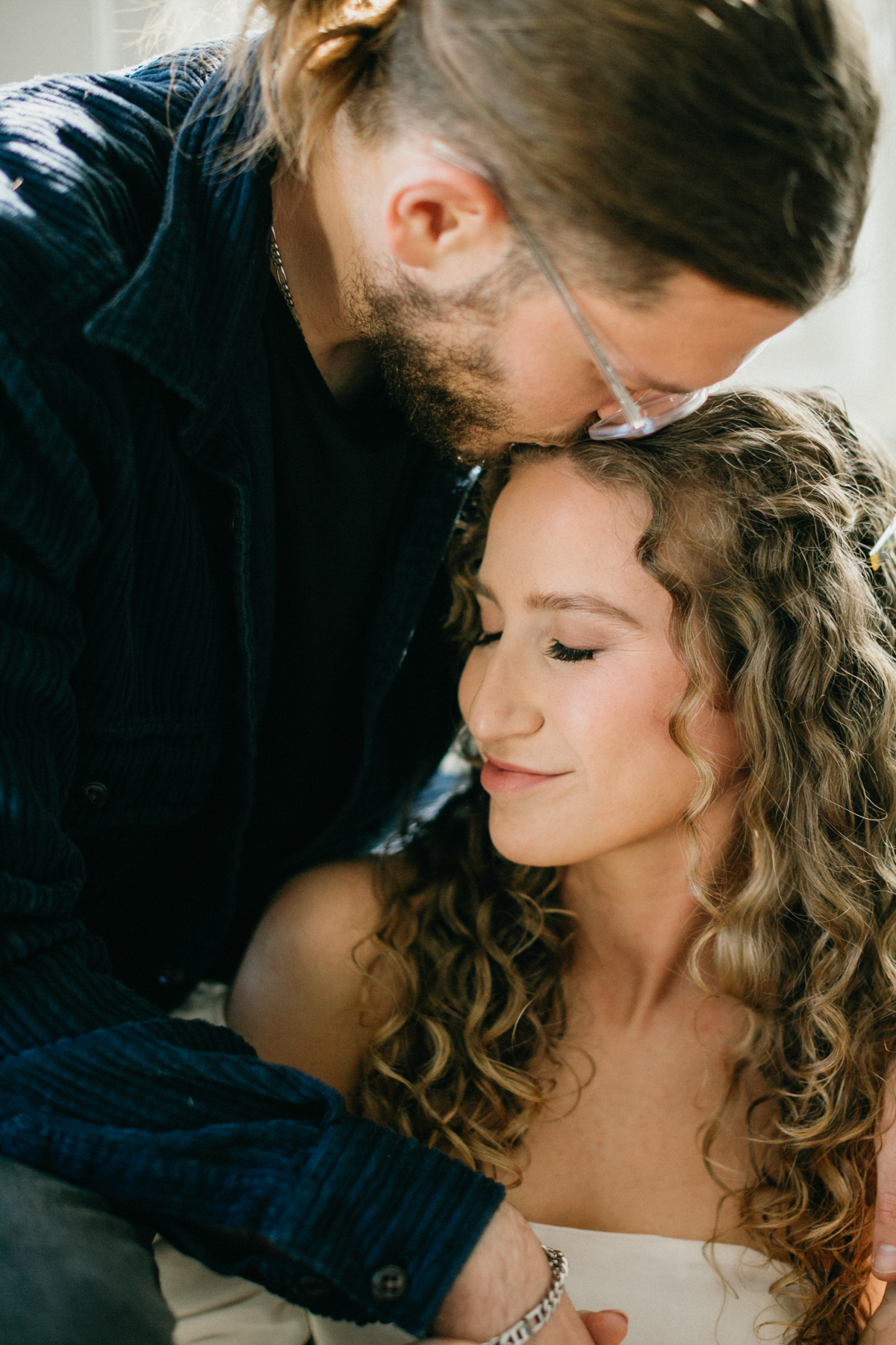 Timeless indoor engagement photo of couple relaxing in their home