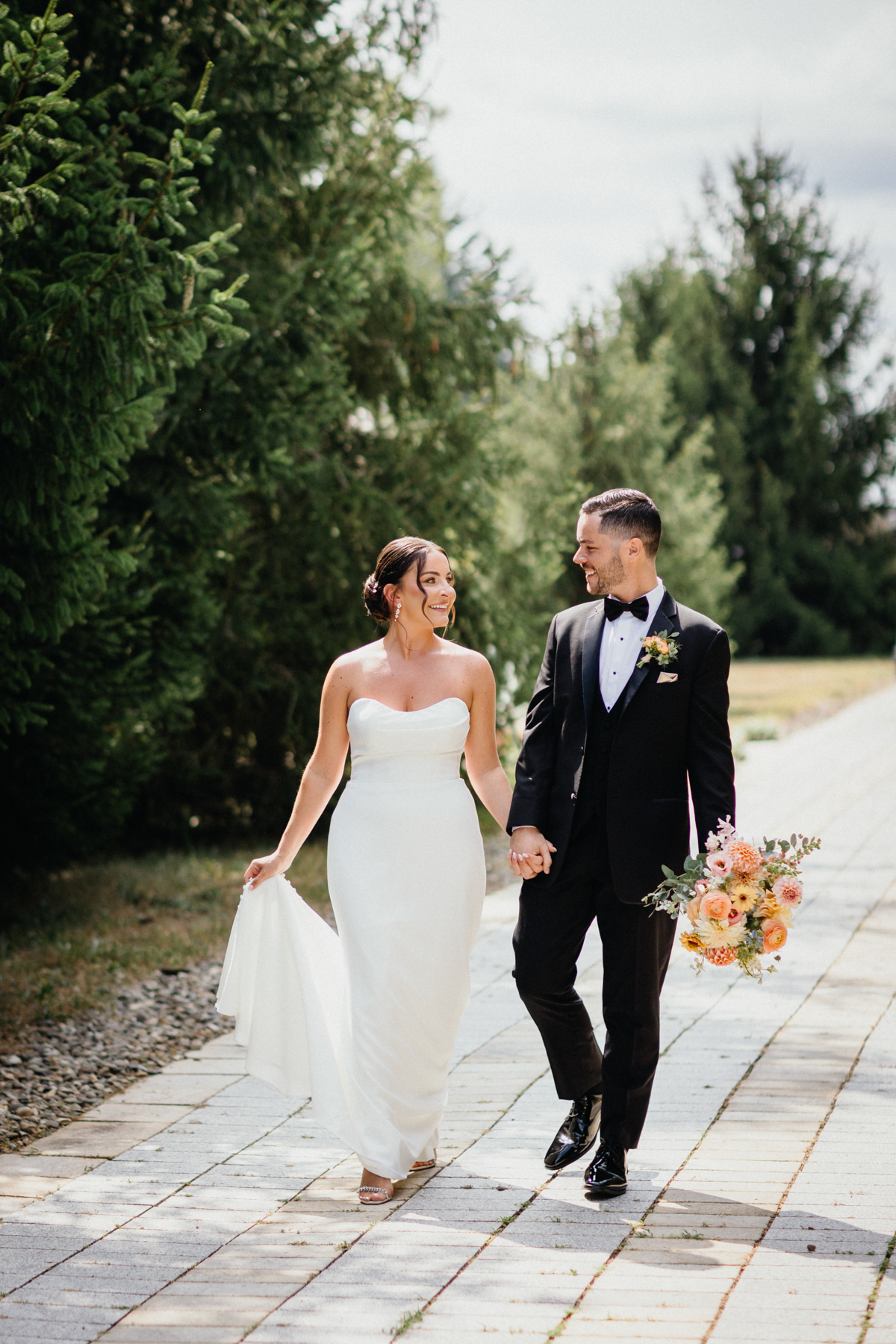 Bride and groom holding hands at Terrain Gardens at DelVal wedding