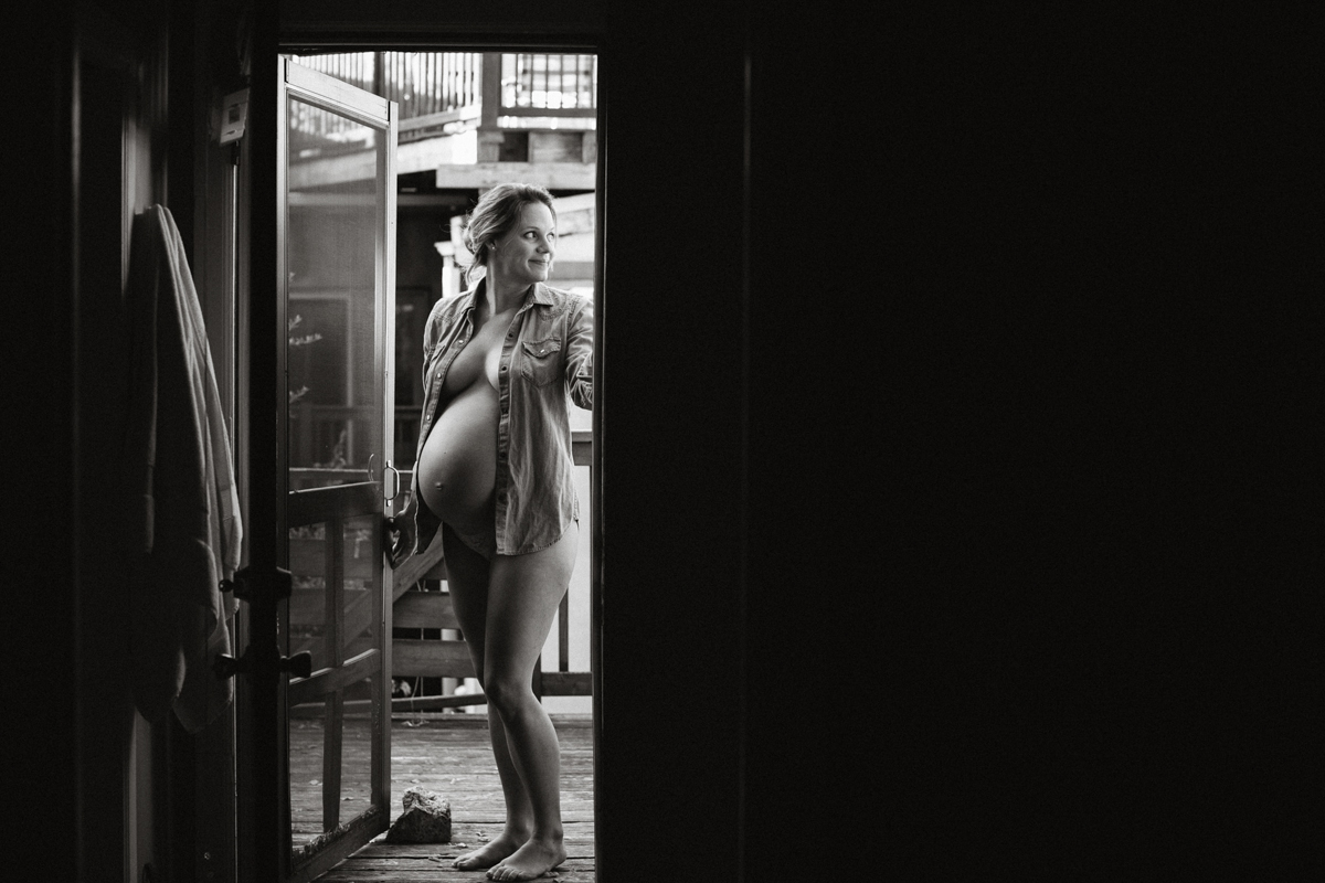 Bare belly maternity portrait in garden doorway in Philly