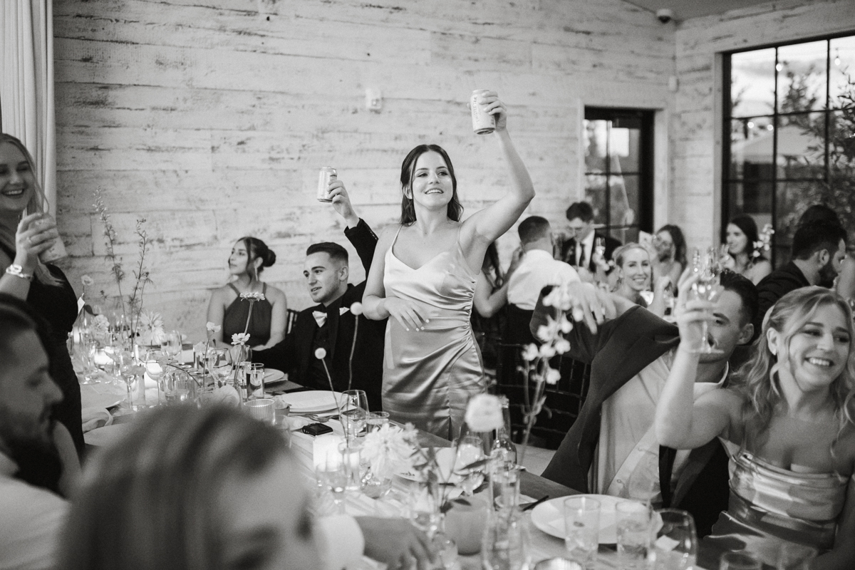 Friends toasting at Terrain Gardens at DelVal wedding