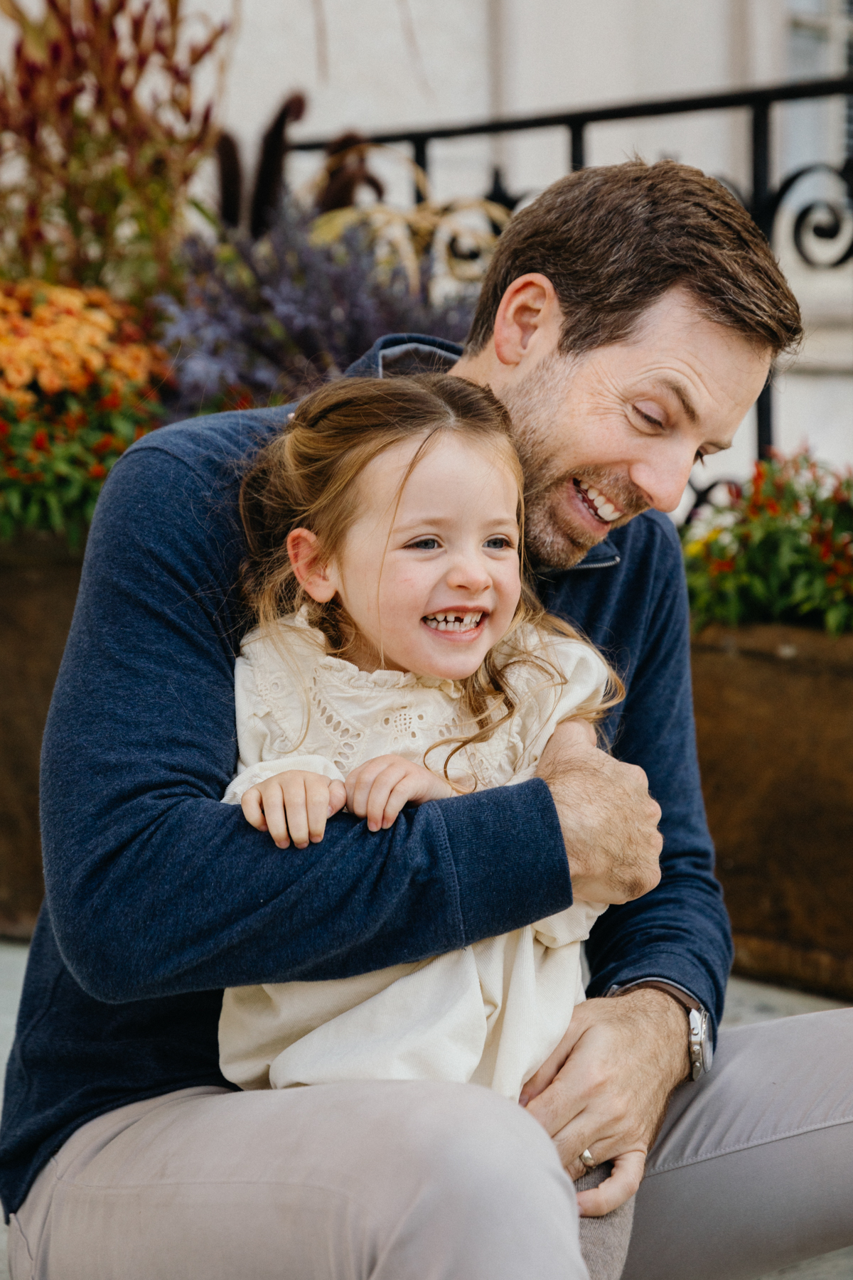 Family photographer in Philadelphia capturing playful garden portraits