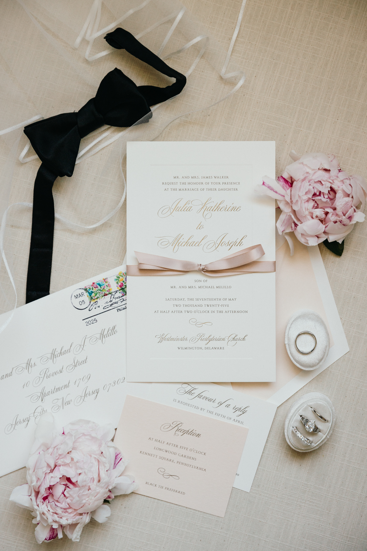 Flat lay of invitation and accessories at Longwood Gardens wedding 