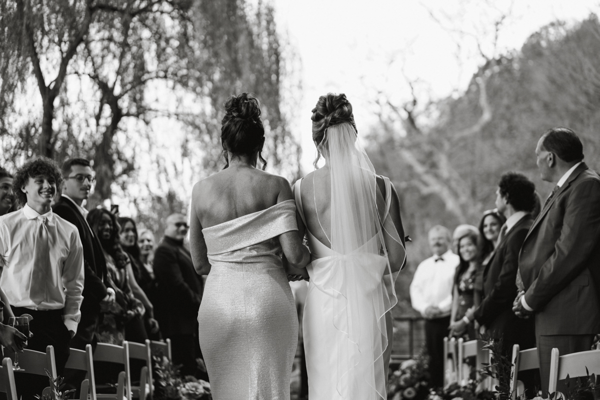 mom walking bride down aisle candid 