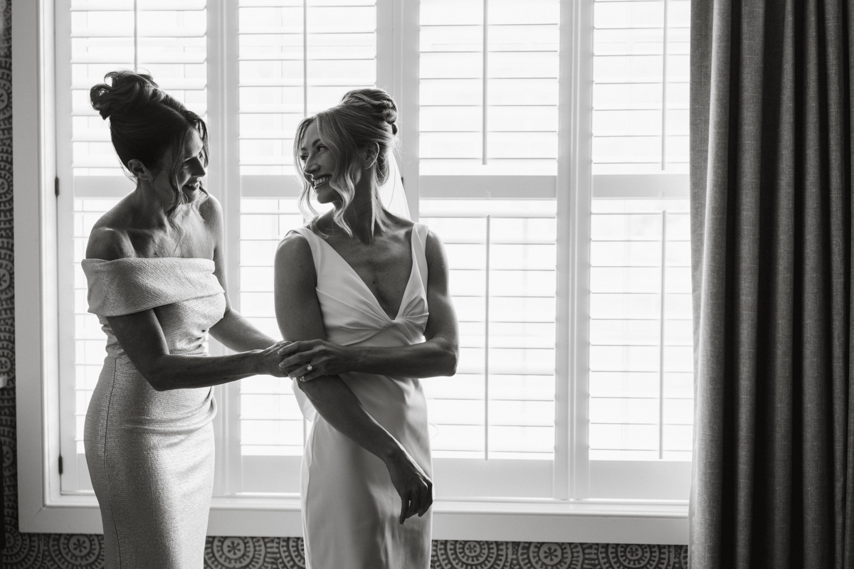 bride getting dressed at odettes wedding