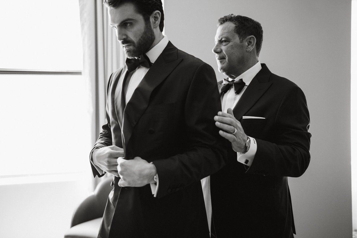 Groom looking out window at high-end Philadelphia wedding