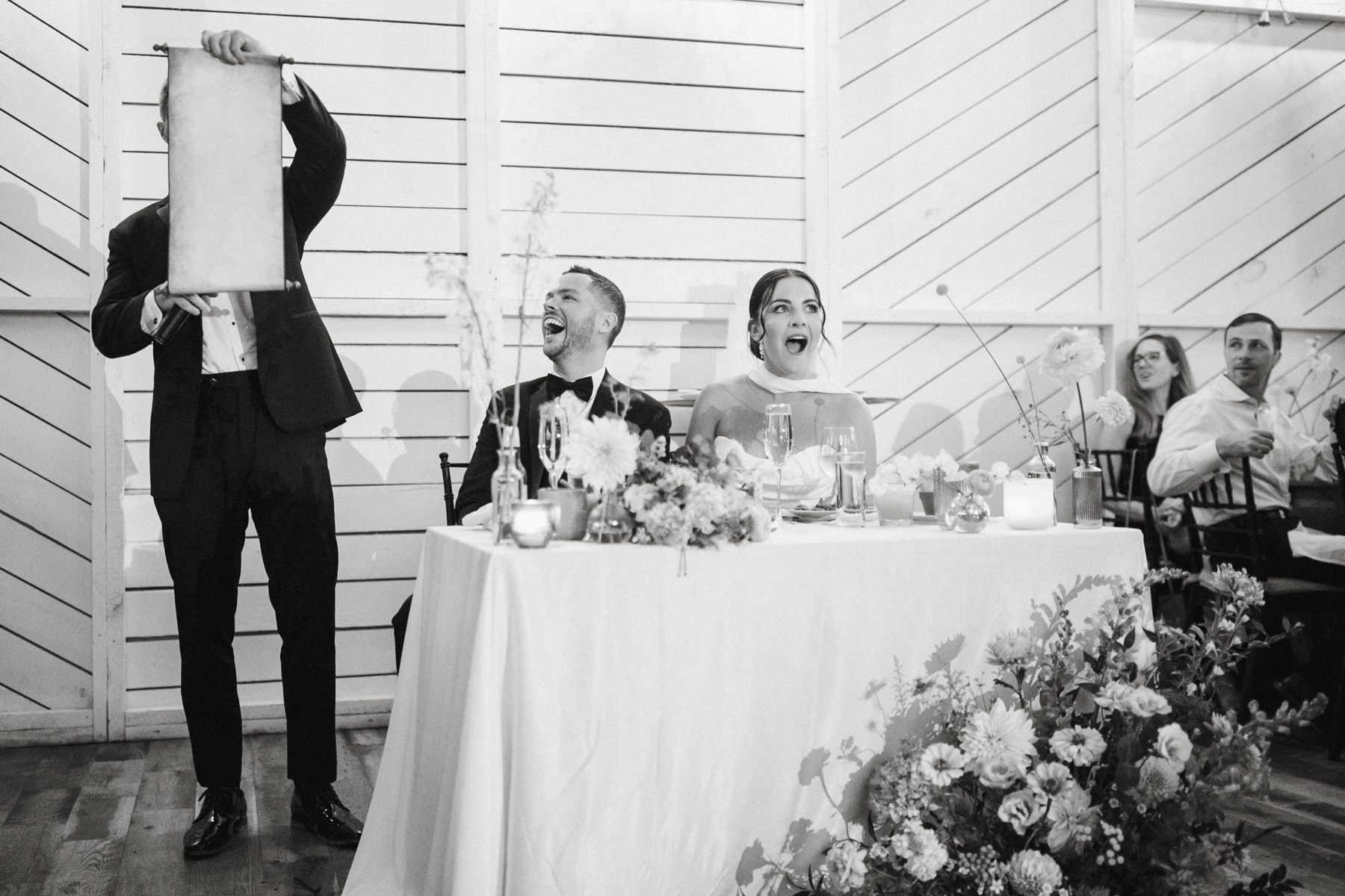 Groom smiling at Terrain Gardens at DelVal wedding