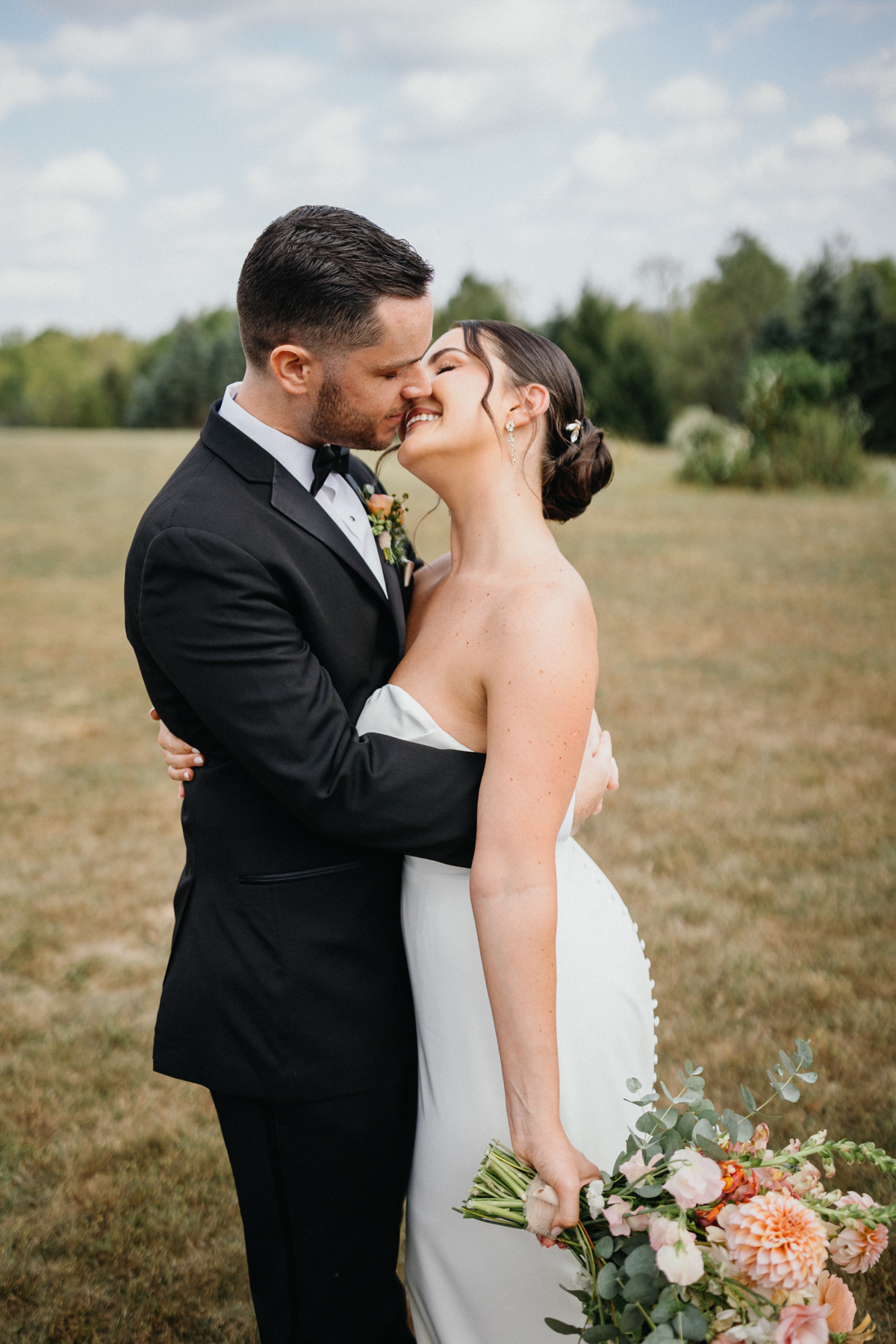Couple embracing during golden hour at Terrain Gardens at DelVal wedding