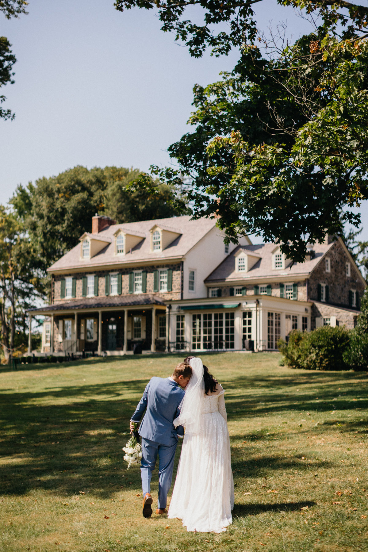 Couple standing on a hillside at Grace Winery wedding