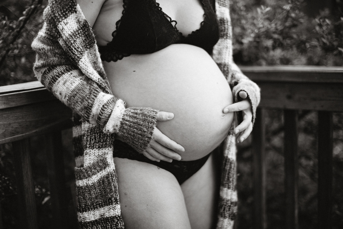 Intimate moment of mom-to-be in home garden in Philly