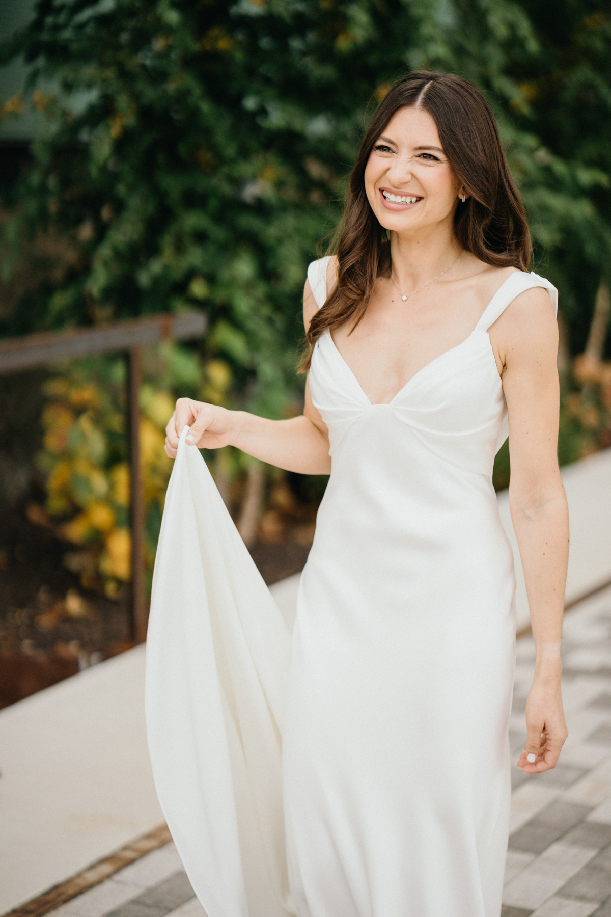 Bride’s dress flowing on bridge at Pencoyd Landing wedding