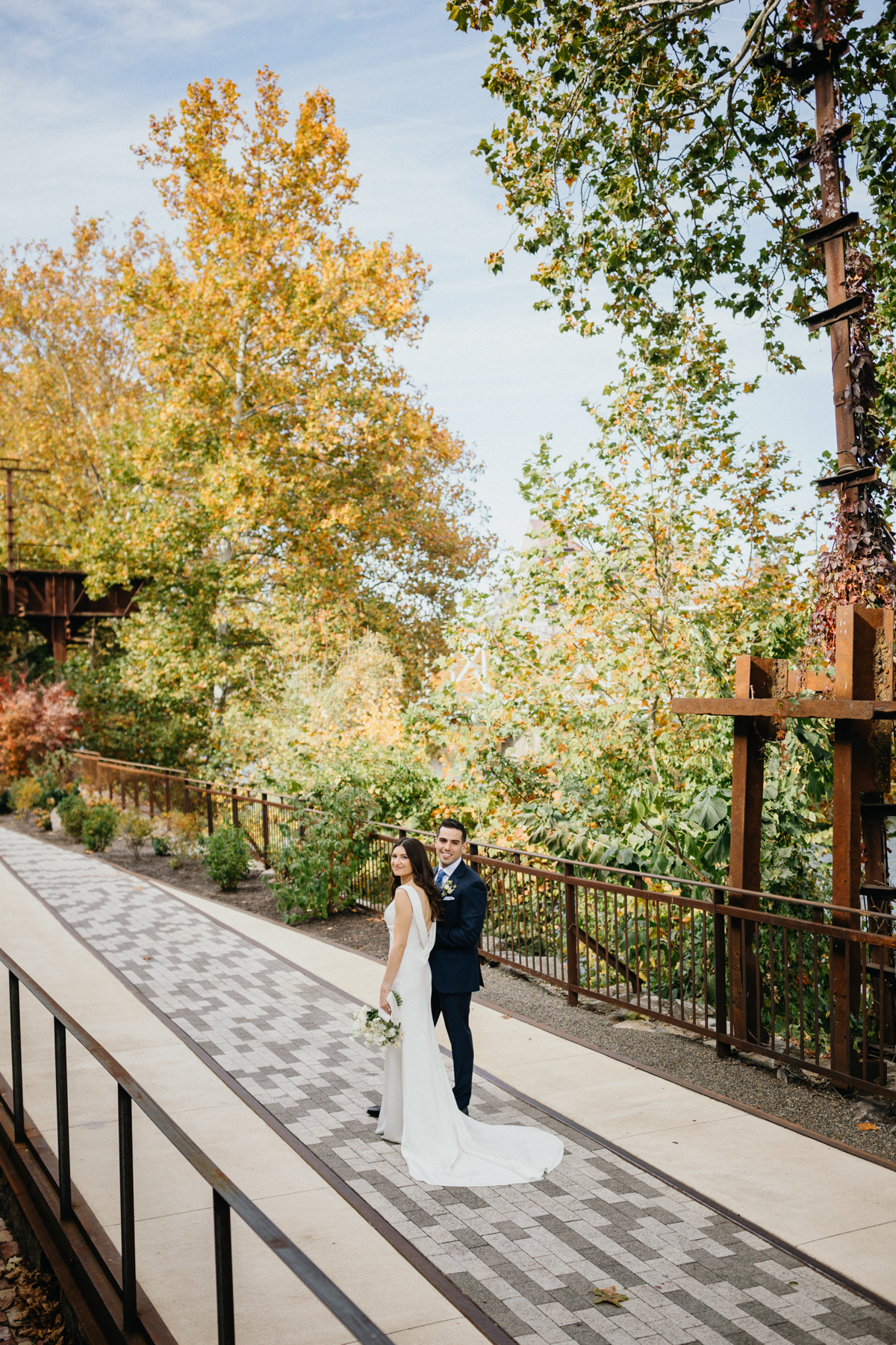 Industrial wedding portrait under steel bridge