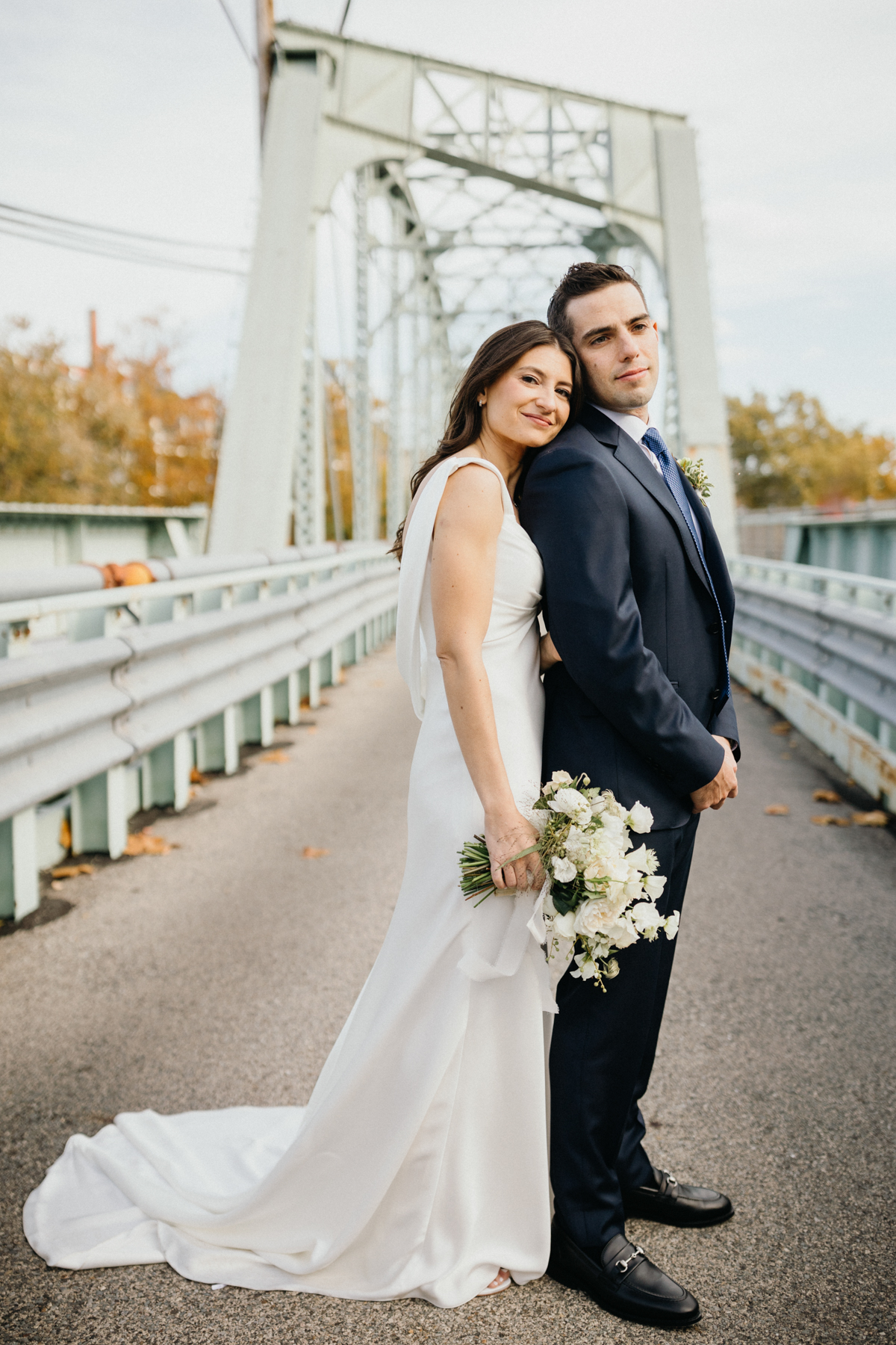 Romantic couple portrait on bridge at Ironworks wedding venue
