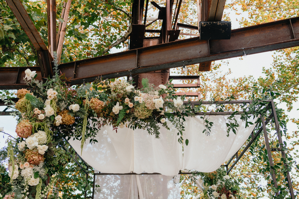 White floral chuppah set up at Train Shed ceremony site