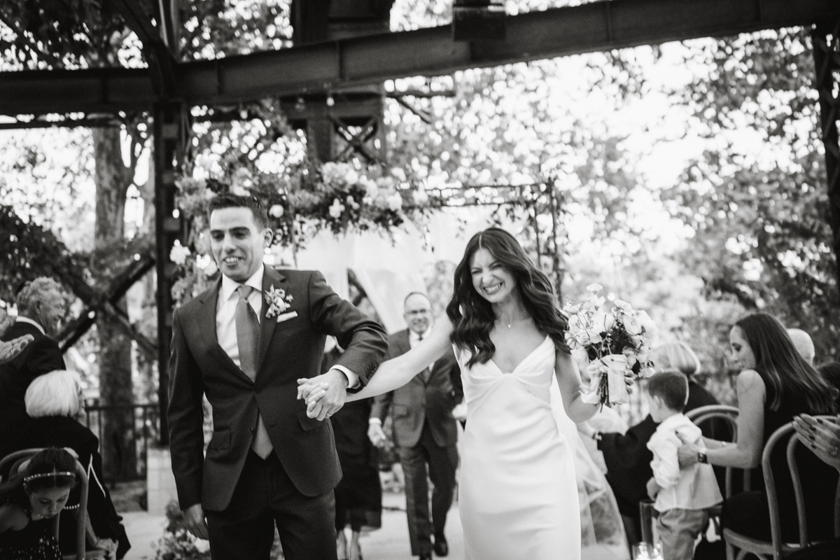 Candid smiles during ceremony at Train Shed