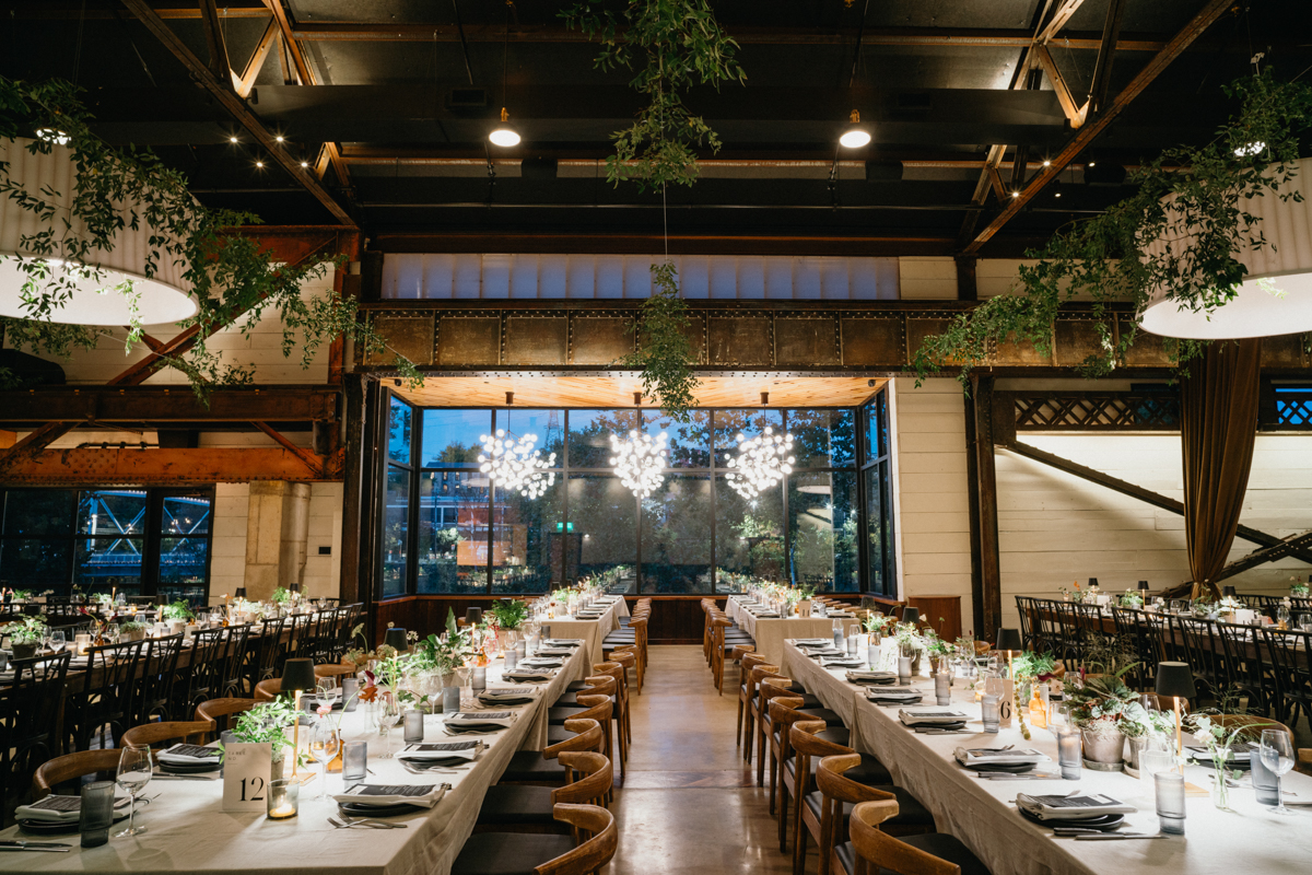 Reception tables with modern black chairs and white florals