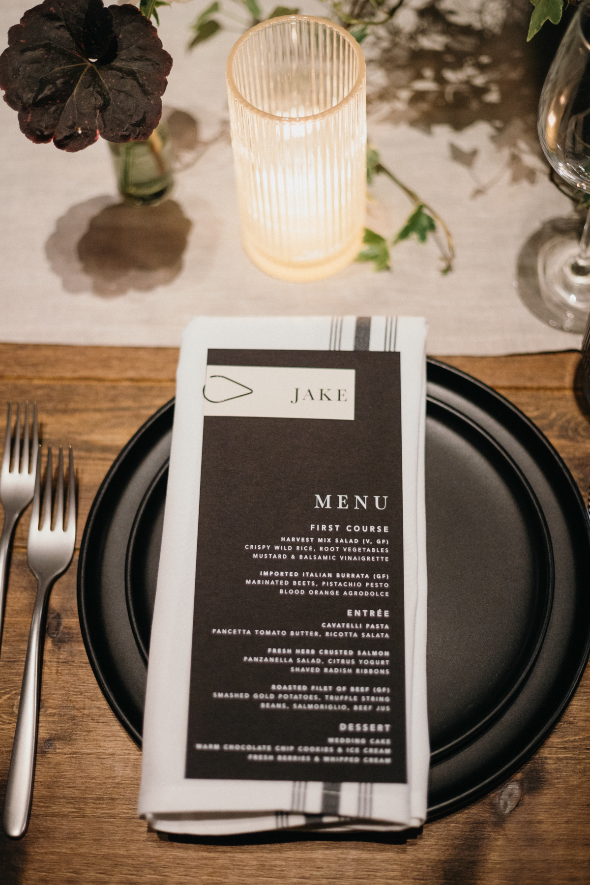 Elegant place setting with white florals and black napkin at industrial Philly venue