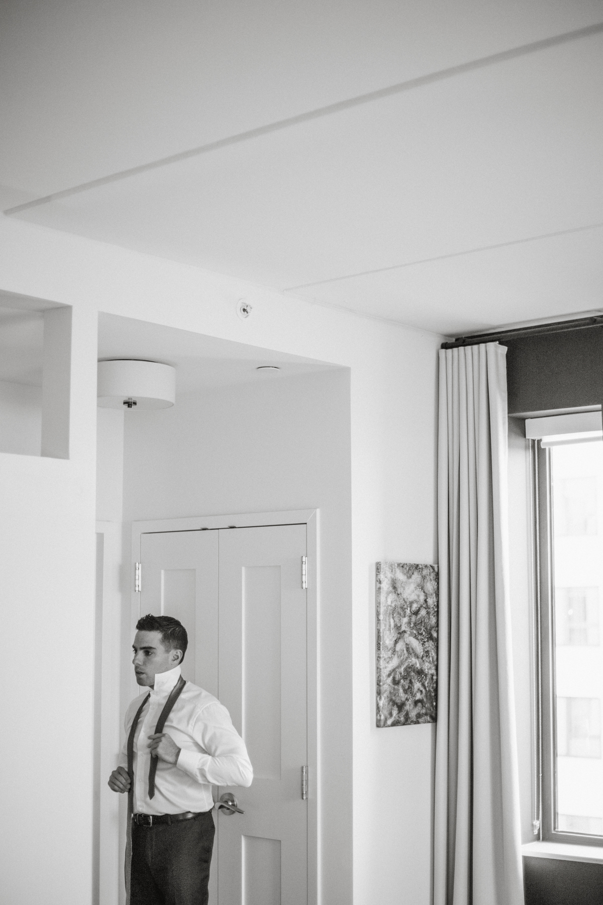 Groom adjusting cufflinks before Pencoyd Landing wedding