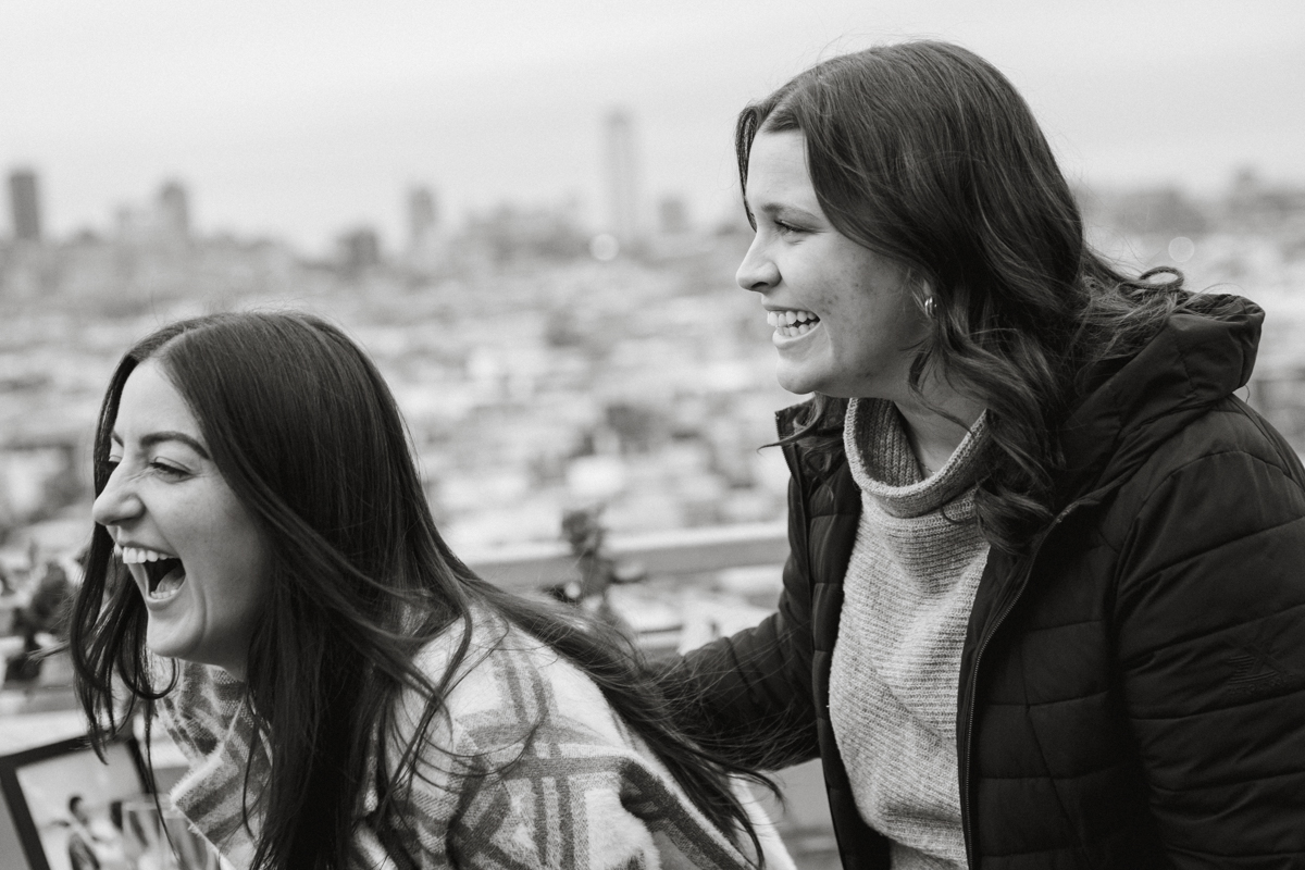 Emotional proposal moment overlooking Philadelphia skyline
