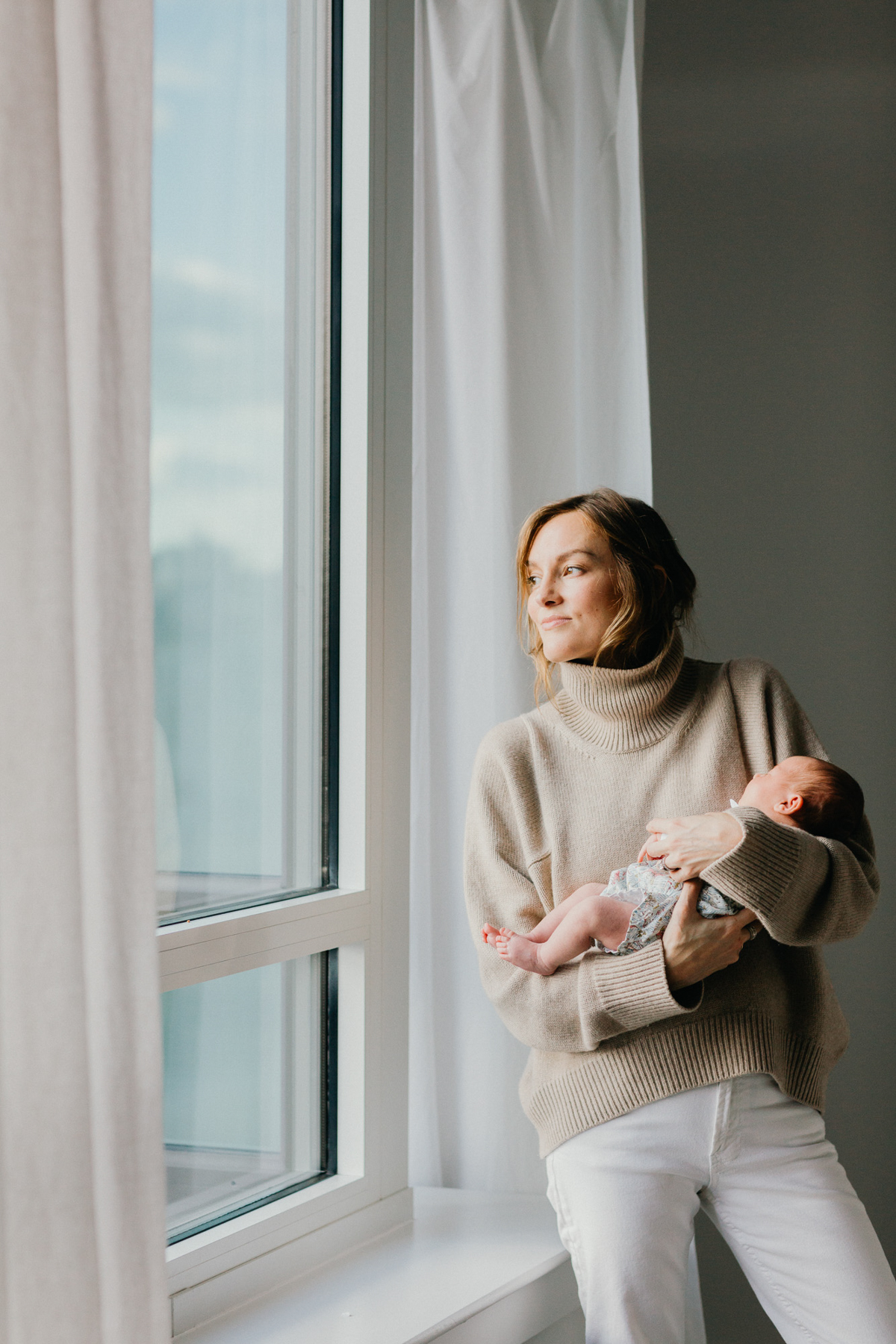 Philadelphia newborn photographer parents holding tiny baby girl