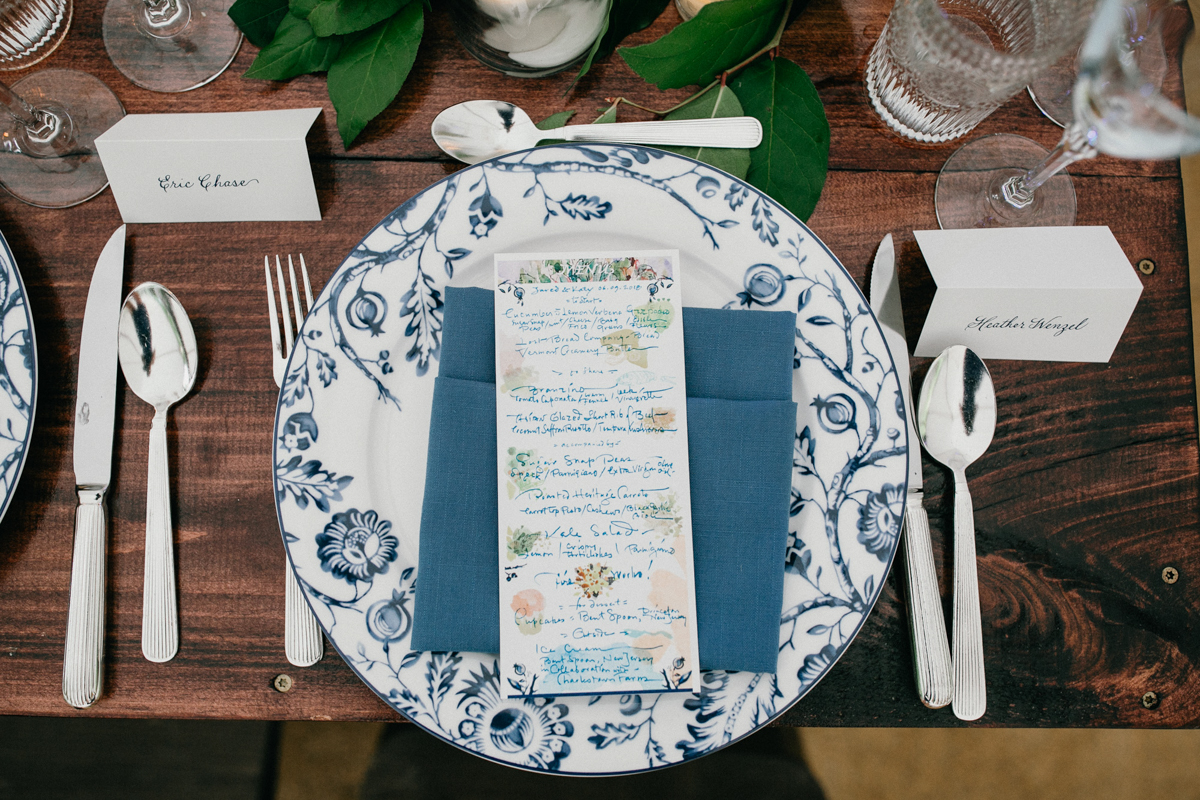 handwritten wedding menus on blue and white china