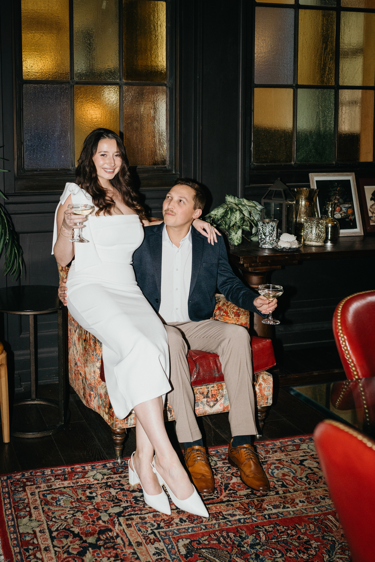 Couple with martinis during restaurant engagement photos in Philly