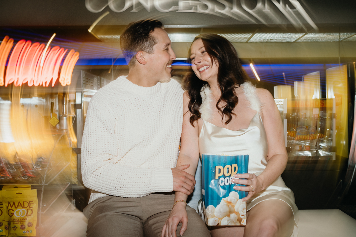 Fun movie theater engagement session in Philadelphia with popcorn