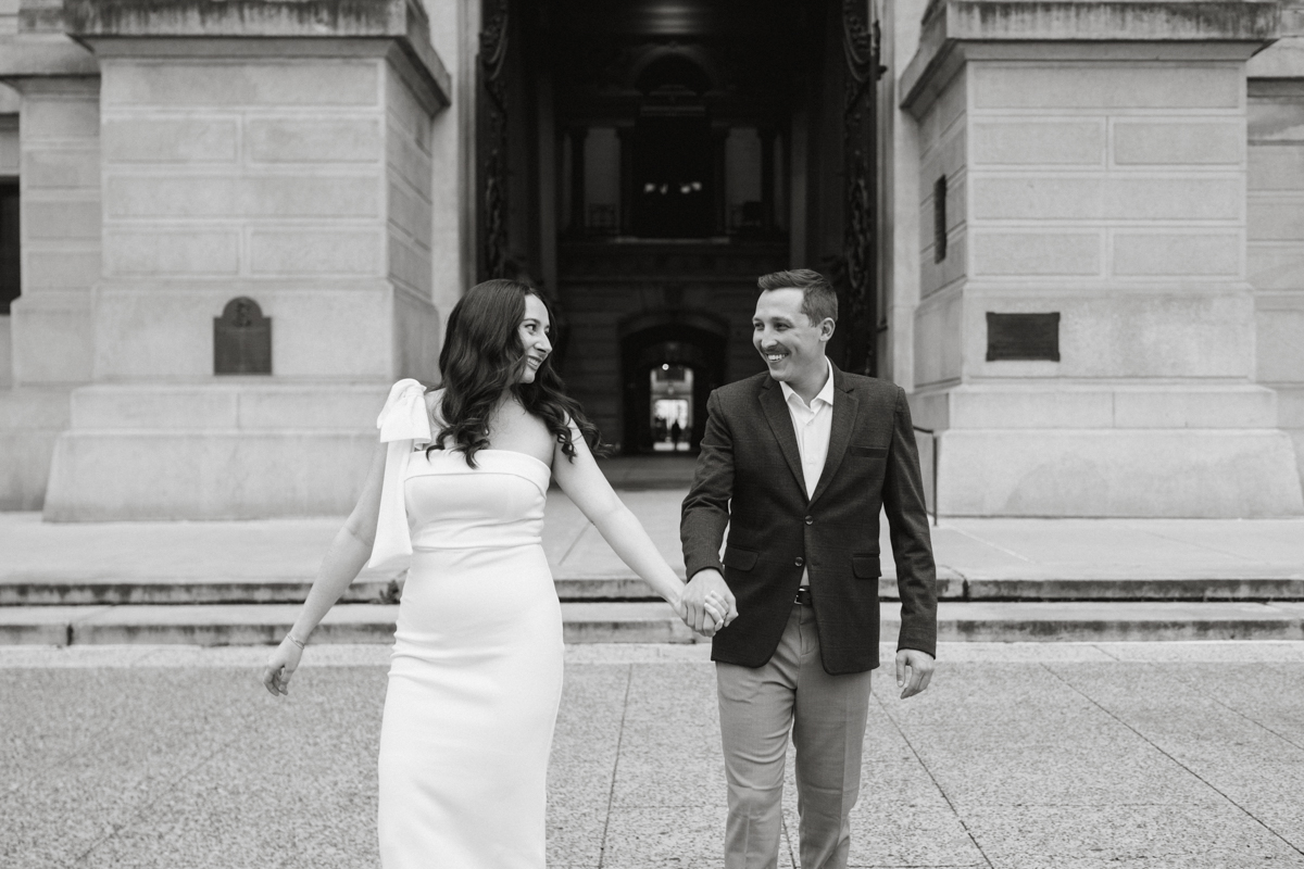 Walking hand in hand during a Philly engagement session downtown