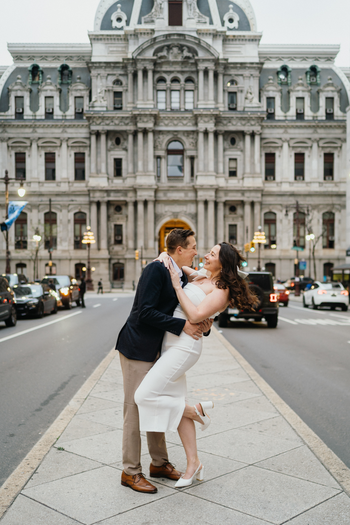Philly engagement photos with couple kissing on Broad Street
