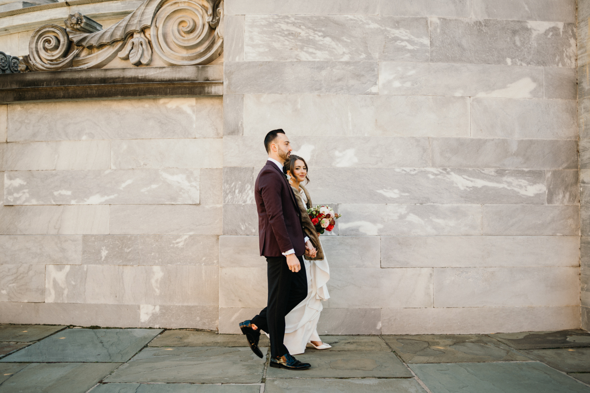 Bride and groom at Merchants’ Exchange by a Philadelphia editorial wedding photographer