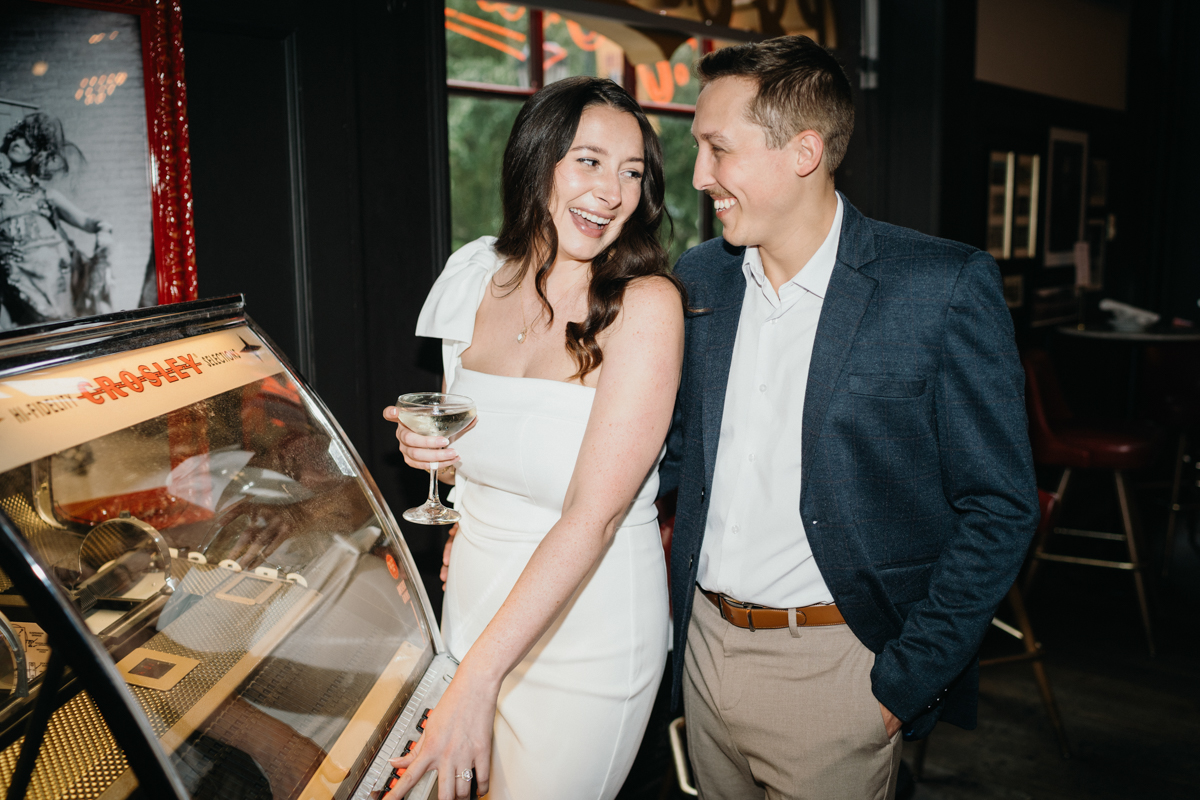 Candid laughter during restaurant engagement photos at PJ Clark’s